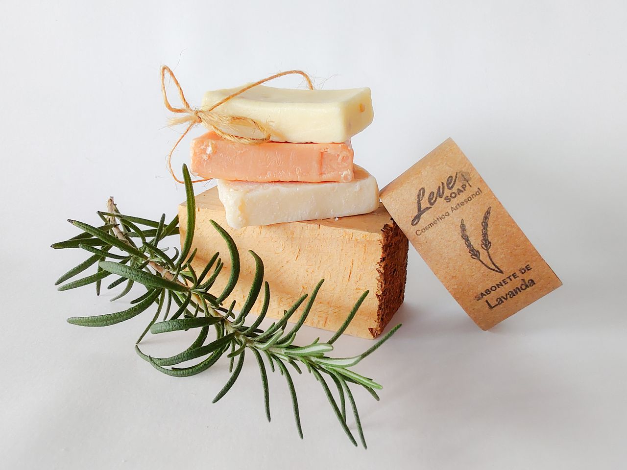 Stacked artisanal soaps with rosemary and lavender, showcasing natural skincare.